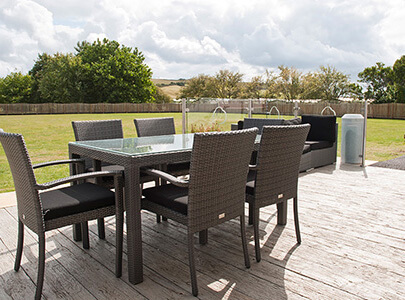 AB Sundecks Decking behind building with an array of chairs and tables