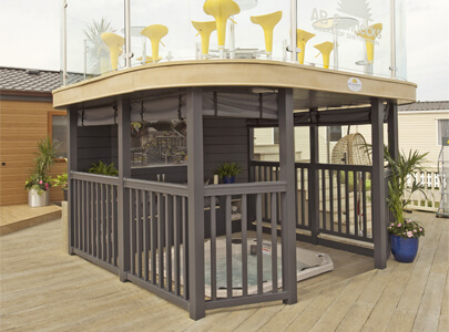 AB Sundecks Handrails and Platform with Picket Panel and Steel Glass surrounding Hot Tub with an array of chairs and tables above
