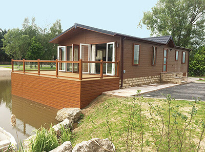 AB Sundecks Picket Glass on raised decking on water over looking the lake